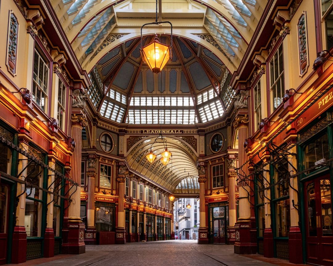 Painted Victorian ironwork and glass roof of Leadenhall Market in the City of London